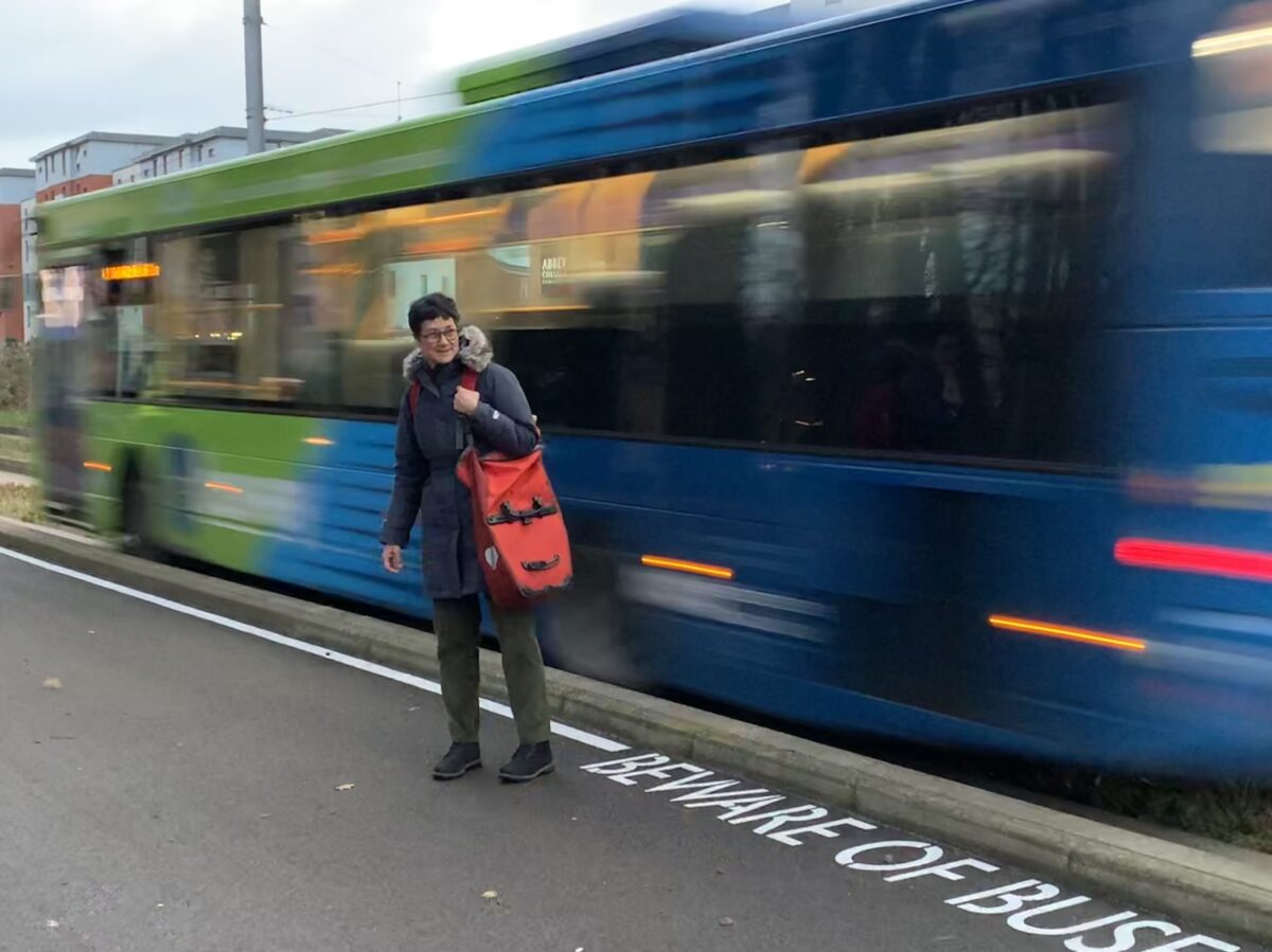 Katie Thornburrow on the guided busway, with a bus passing at speed