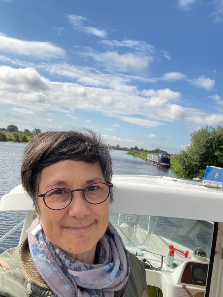 Katie on the river manager's boat, inspecting the Cam