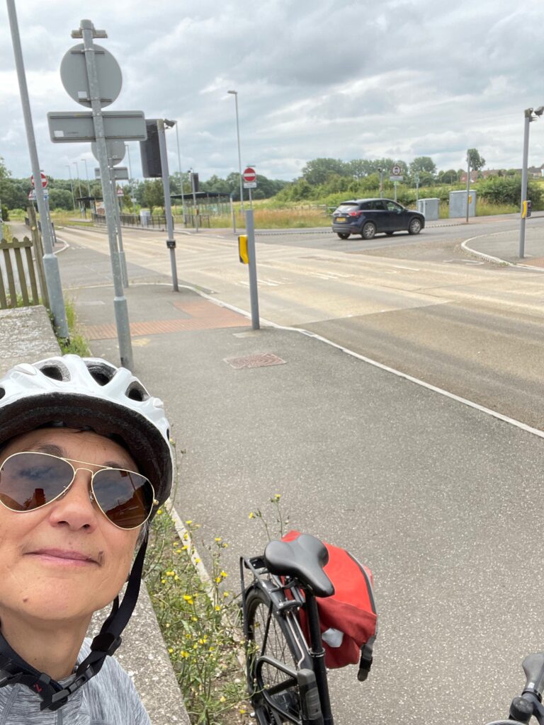 Katie in a cycle helmet, with the guided busway visible