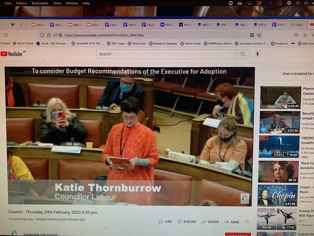 Screenshot of council meeting livestream, with Katie speaking