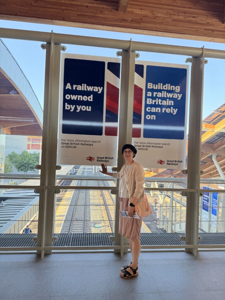 
Katie on the bridge, with the Great British Railways poster