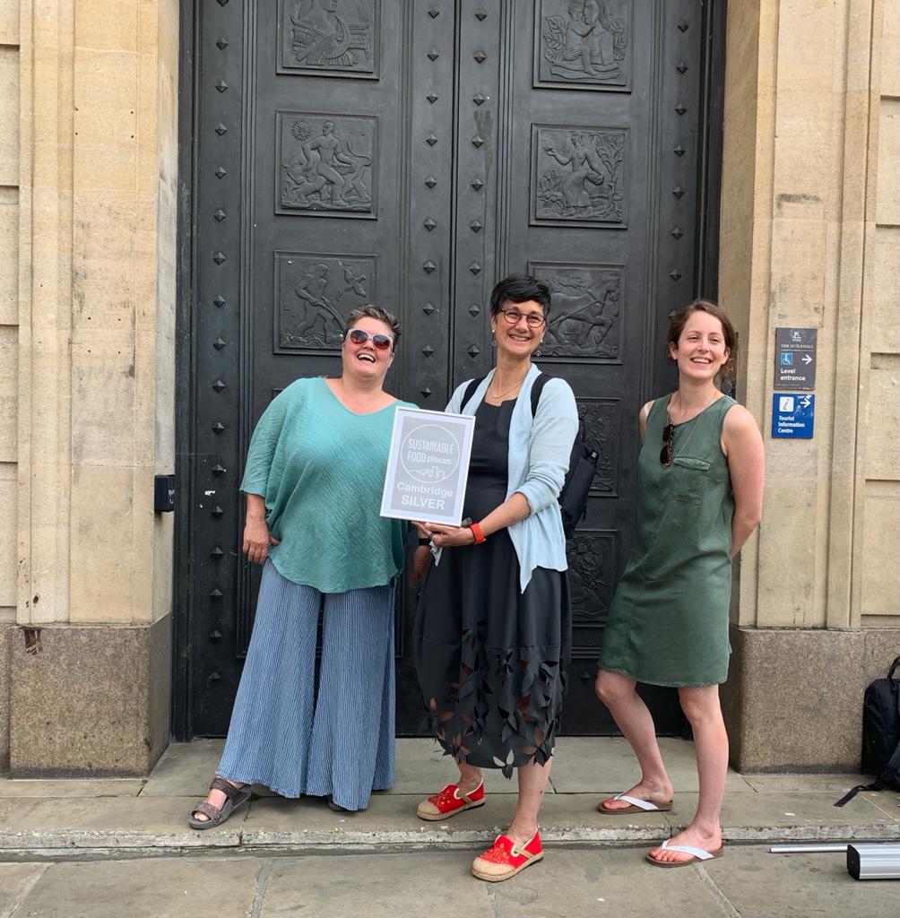 Sam Dyer, Katie Thornburrow and Gemma Birley outside The Guildhall in 2024 with the Sustainable Food Place Gold award received by Cambridge Sustainable Food Partnership